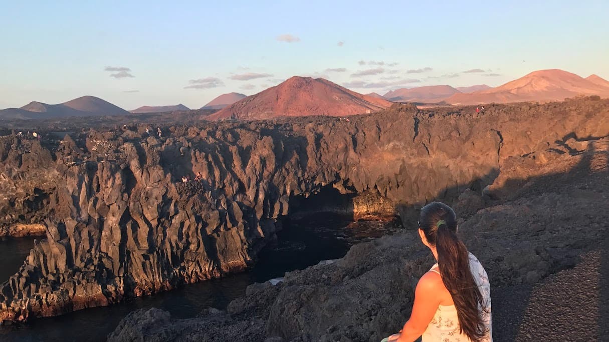 Local guide overlooking the volcanic Lava Coast in Lanzarote